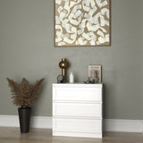Commode blanche avec un cadre décoratif délicat, petite table de chevet dans le couloir de la chambre, armoire, buffet, buffet haut avec tiroirs